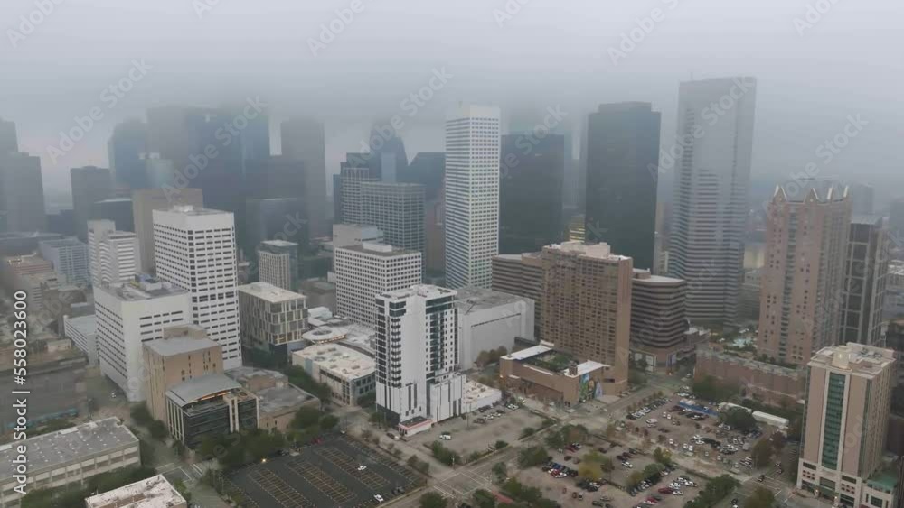 Aerial view of downtown Houston skyline covered in fog - tracking, drone shot Aerial view of downtown Houston skyline covered in fog - tracking, drone shot
