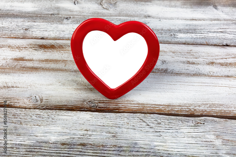 Red heart pattern picture frame standing up on a white wood desk background for a happy Valentines day setting Red heart pattern picture frame standing up on a white wood desk background for a happy Valentines day setting