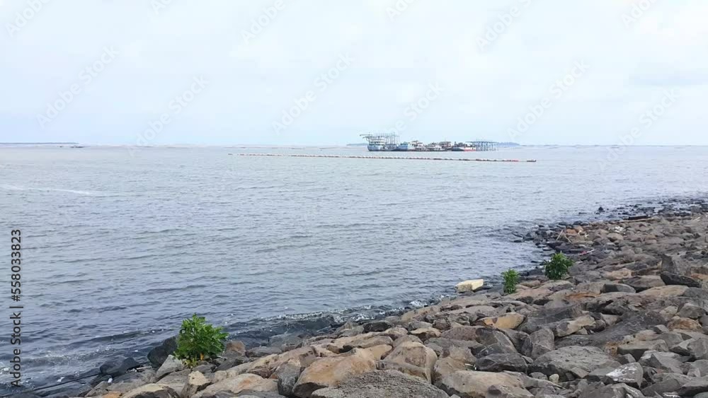 Pier of rocks by the sea and ships on the sea Pier of rocks by the sea and ships on the sea