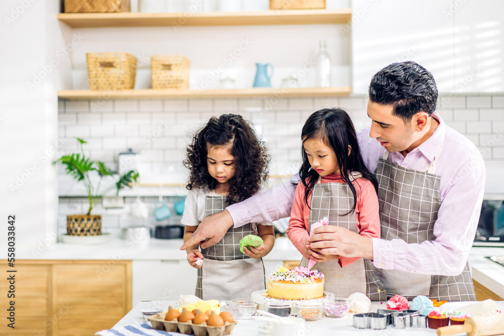 Portrait of enjoy happy love asian family father and little asian girl daughter child play and having fun cooking food together with baking cookie and cake ingredient in kitchen Portrait of enjoy happy love asian family father and little asian girl daughter child play and having fun cooking food together with baking cookie and cake ingredient in kitchen