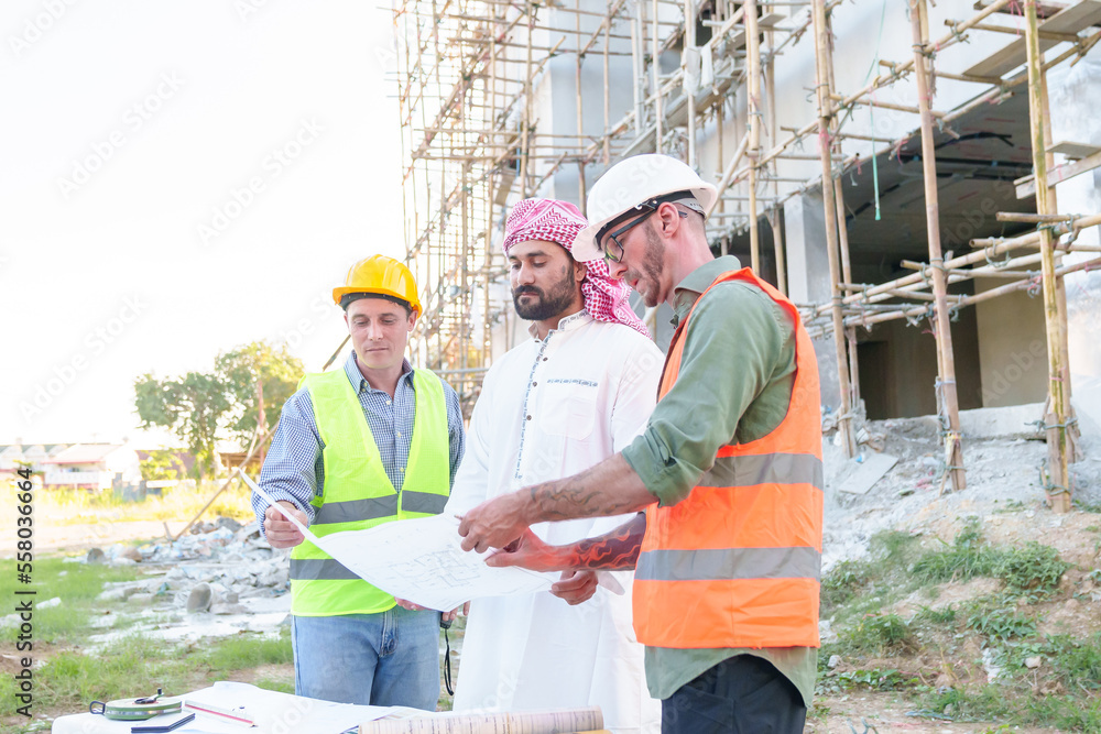 Diverse team of professionals using tablet computers on construction site. Real estate construction project. with civil engineers, architects, Arabic business investors and explorer with theodolite Diverse team of professionals using tablet computers on construction site. Real estate construction project. with civil engineers, architects, Arabic business investors and explorer with theodolite