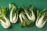 Fresh pak choi cabbages on green background, closeup