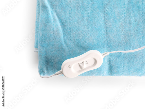 Blue electric heating pad with controller on white background, closeup