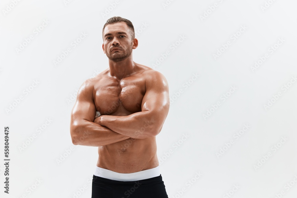 Fototapeta premium Man athletic body bodybuilder in briefs with naked torso abs full-length in the background, fitness classes. Advertising, sports, active lifestyle, competition, challenge concept.