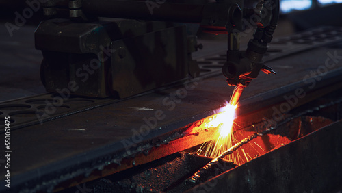 Plasma cutting metalwork industry machine with sparks in factory