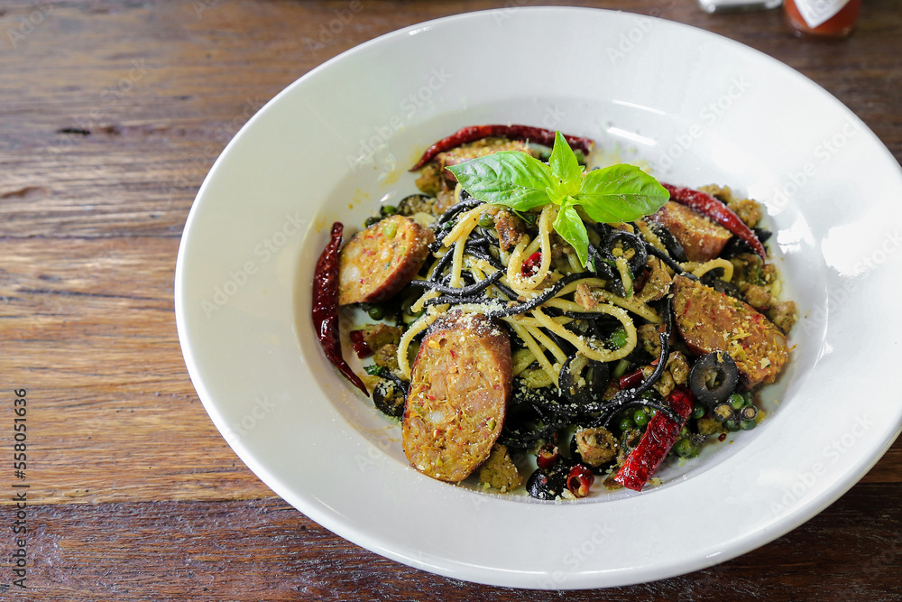 plate of black spaghetti with Sausage and Black olives plate of black spaghetti with Sausage and Black olives