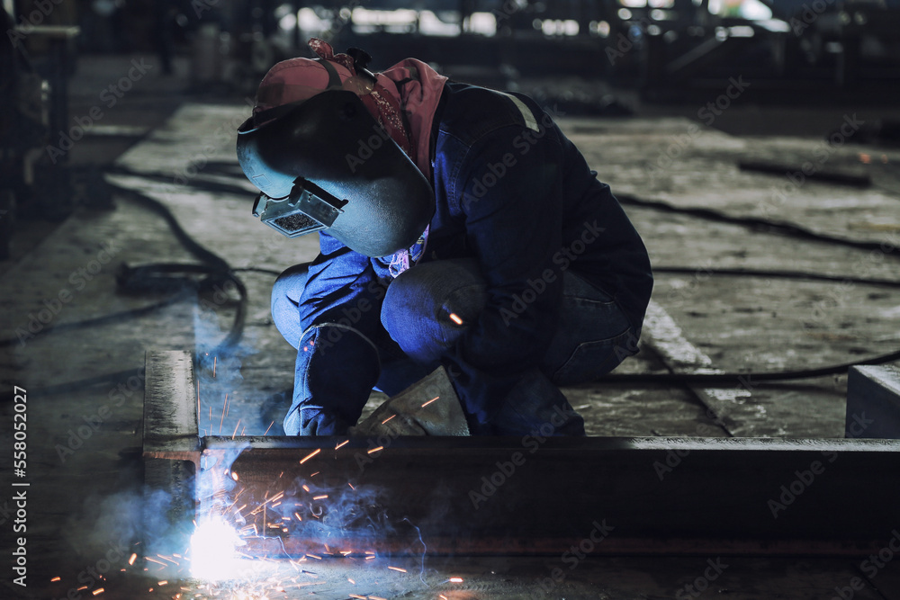 Worker with protective mask welding metal Worker with protective mask welding metal