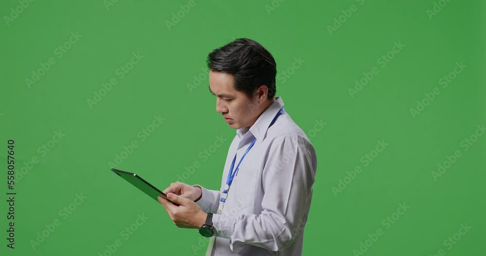 Side View Of Asian Business Man Not Satisfied And Shakes His Head While Using Tablet On Green Screen Studio
Side View Of Asian Business Man Not Satisfied And Shakes His Head While Using Tablet On Green Screen Studio