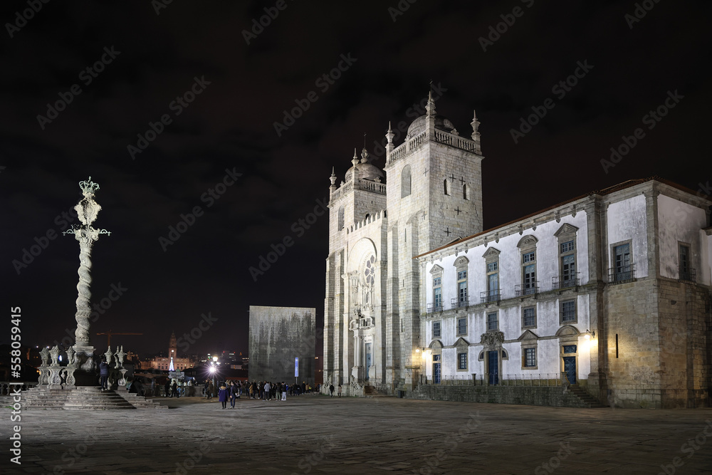Porto, Portugal - December 07, 2022: details of the Porto Cathedral facade and the square in front of the main entrance, with tourists taking pictures in Porto, Portugal