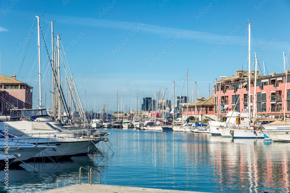The old port with moored yachts against the backdrop of old beautiful houses on a sunny day with a bright blue sky. Leisure.