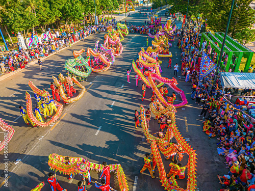 Top view of dragon dance perform celebration new year. Group of people perform a traditional lion dance and dragon dance. Guinness record performance of 54 Dragons dance on the street Vung Tau.