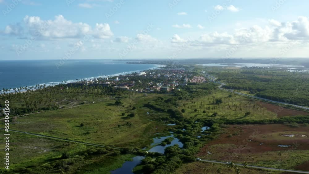 Tilt-up aerial drone shot revealing the beautiful tropical coastline of the famous tourist beach of Porto de Galinhas or Chicken Port in Pernambuco, Brazil on a warm sunny summer day. Tilt-up aerial drone shot revealing the beautiful tropical coastline of the famous tourist beach of Porto de Galinhas or Chicken Port in Pernambuco, Brazil on a warm sunny summer day.