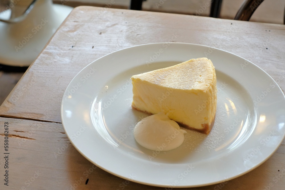 cheese cake with cream on white plate cheese cake with cream on white plate