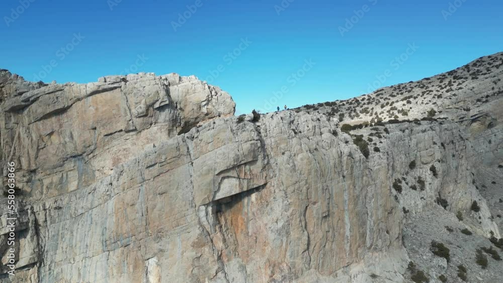 successful climbers on the cliffs of the peak mountains and stunning views successful climbers on the cliffs of the peak mountains and stunning views