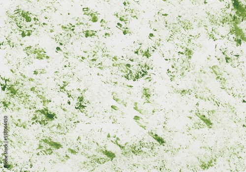 Acrylic paint in grass green dabbed on a sheet of paper
