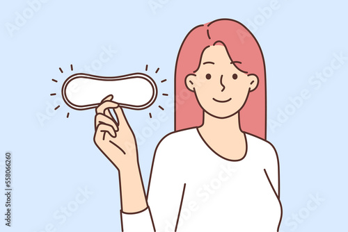 Woman holding pad for periods