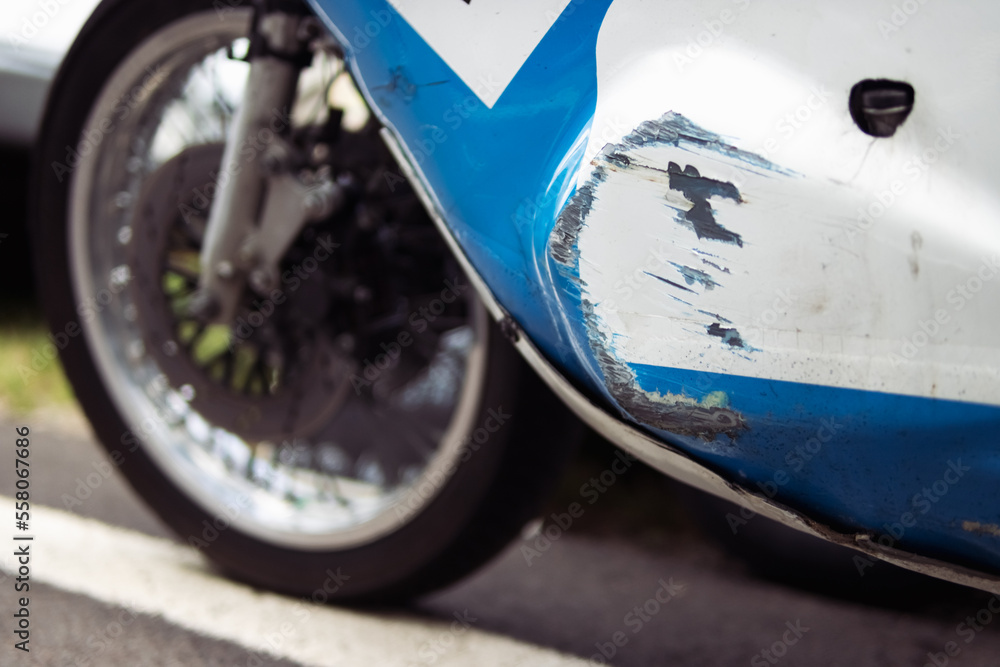 Obraz premium side view photo of a bumper scratched from a racing car close-up of a white-blue color