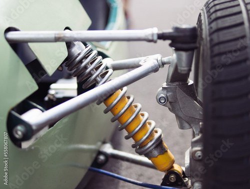 shock absorber and spring closeup on racing car isolated