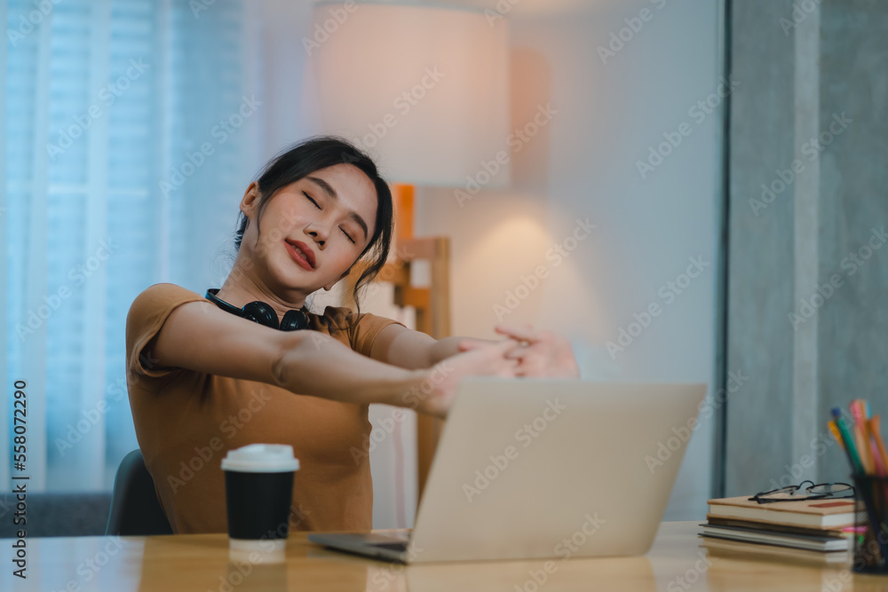 Obraz premium Tired young woman feels acute back pain as working on computer in sedentary posture for a long time. Unhappy stressed student has radiculitis, spasm or pinched nerve inflammation