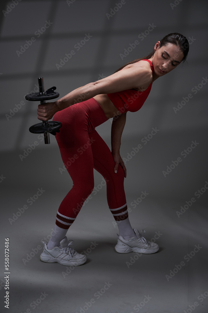 Athletic fitness woman working out, studio shot