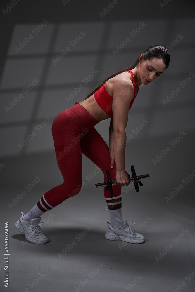 Naklejka premium Athletic fitness woman working out, studio shot