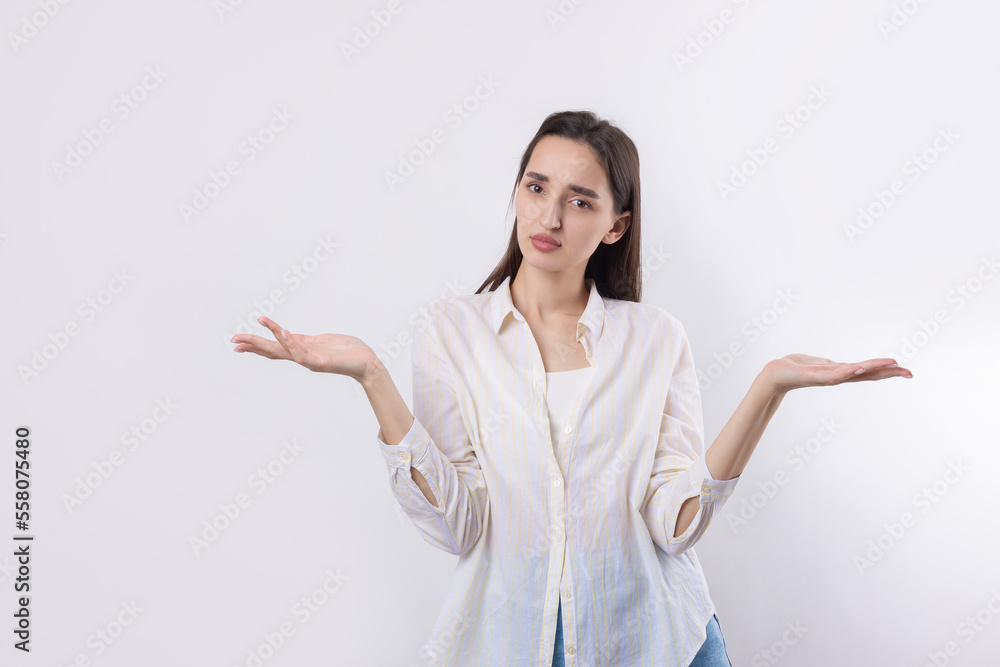 Young beautiful woman with facial expression of surprise standing over white background. Young beautiful woman with facial expression of surprise standing over white background.