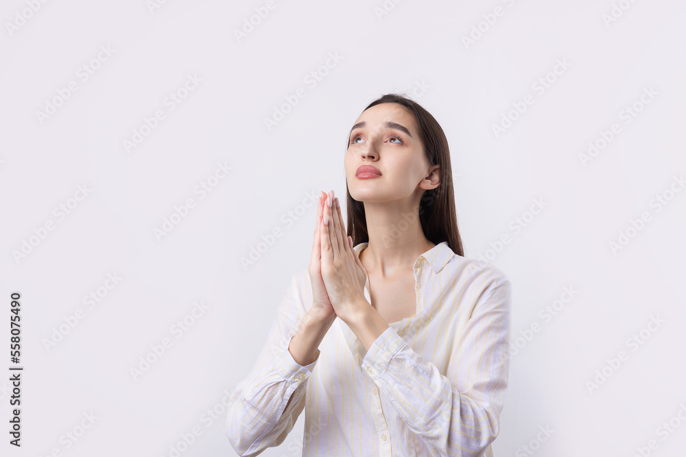 Portrait of a serious young woman showing stop gesture with her palm over white background Portrait of a serious young woman showing stop gesture with her palm over white background