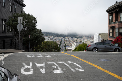 Detail of the steep streets San Francisco. This street makes a sudden descent, foggy urban landscape
