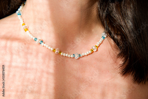 woman with blue and yellow necklace