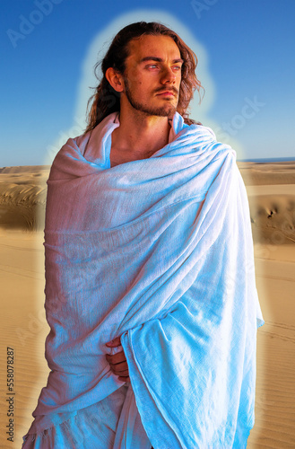 Obraz na płótnie Holy, handsome man with a halo in white robe in desert - looks like Jesus w salonie