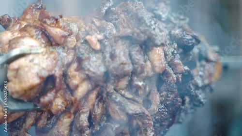 Wallpaper Mural Close up shot of juicy sizzling meat with crispy crust rotating on barbecue skewer, smoking meat tenderloin grilling on burning fire, preparation of barbecue delicacy, street or junk food cookout Torontodigital.ca