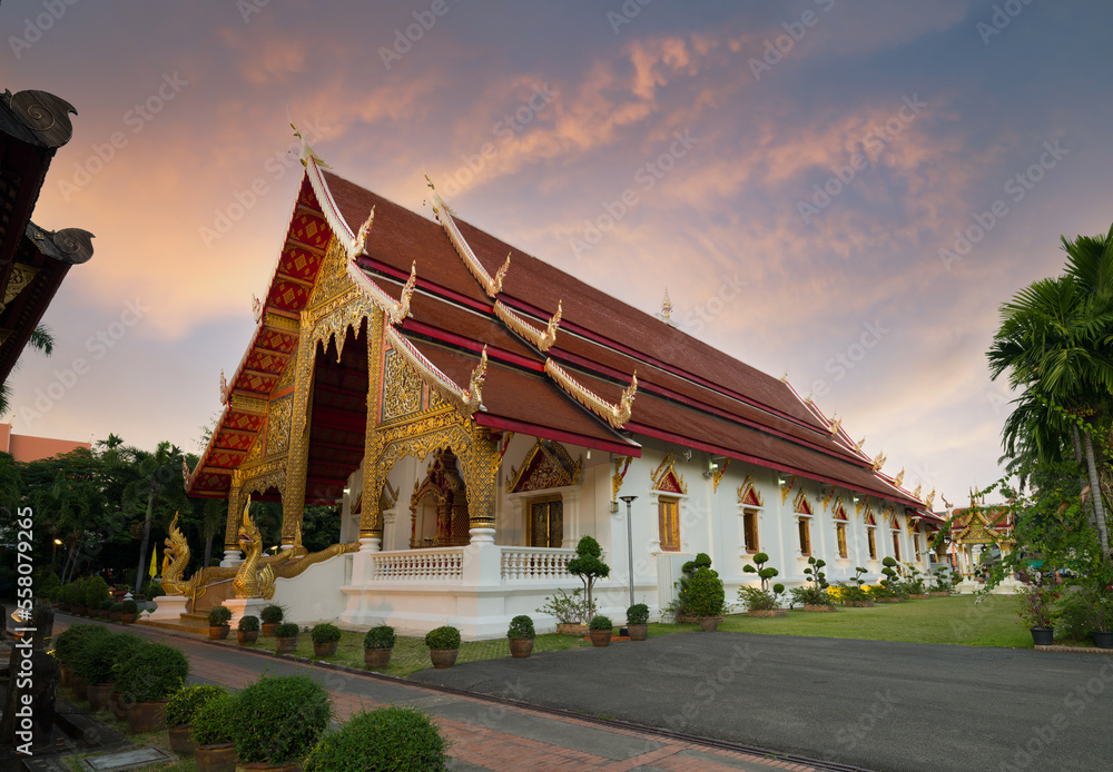 Wat Phra Singh Woramahawihan Buddhist Temple at sunset . It is one of the most popular tourist destinations in Chiang Mai City. North Thailand 