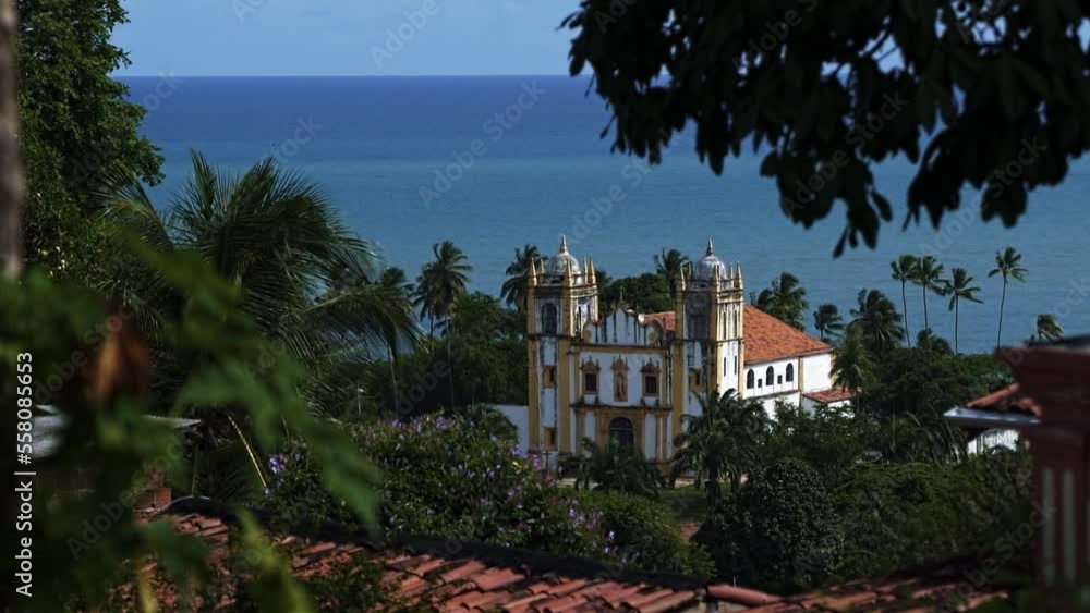 Igreja do Carmo cathedral in the center of the famous old city of Olinda in Pernambuco, Brazil surrounded by tropical flowers and trees. Handheld 120fps slow motion shot on a warm sunny summer day. Igreja do Carmo cathedral in the center of the famous old city of Olinda in Pernambuco, Brazil surrounded by tropical flowers and trees. Handheld 120fps slow motion shot on a warm sunny summer day.