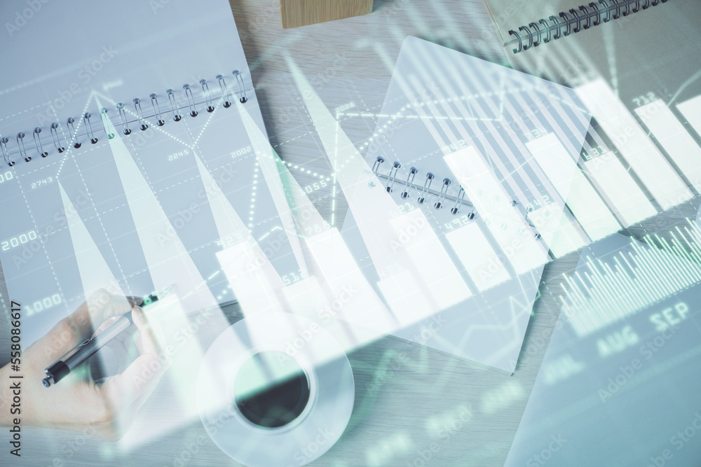 Multi exposure of woman's hands making notes with forex graph hologram. Concept of technical analysis. Multi exposure of woman's hands making notes with forex graph hologram. Concept of technical analysis.