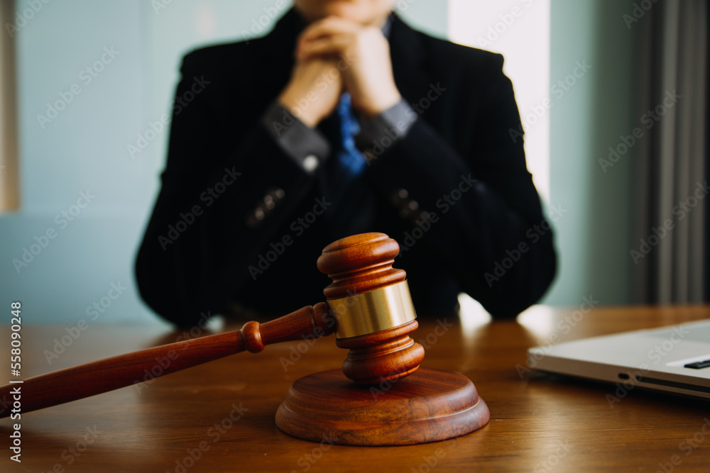 Business and lawyers discussing contract papers with brass scale on desk in office. Law, legal services, advice, justice and law concept picture with film grain effect Business and lawyers discussing contract papers with brass scale on desk in office. Law, legal services, advice, justice and law concept picture with film grain effect