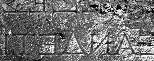 Inscription on the Ancient Greek Carved on Stone in Ancient Necropolis in Pamukkale, Modern Turkey. Monochrome Photo