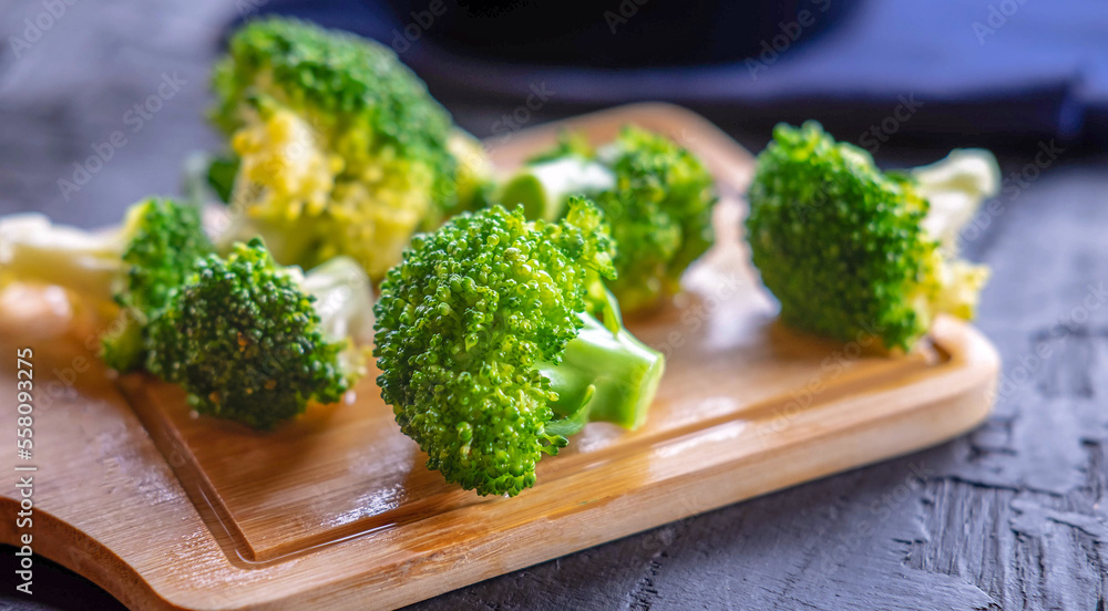 Close-up of  green fresh vegetable broccoli. Fresh green broccoli on wooden table.Broccoli vegetable is full of health .Vegetables for diet and healthy eating.Organic food.