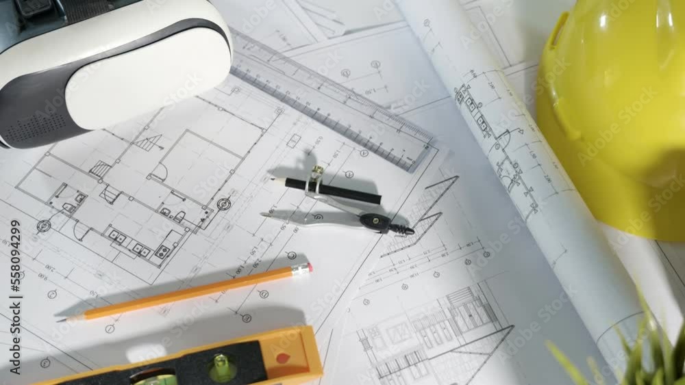 Architect workplace top view. Architectural blueprint paper project plans on desk table, tool for engineer contractor building design working drawing and VR glasses, industry virtual technology Architect workplace top view. Architectural blueprint paper project plans on desk table, tool for engineer contractor building design working drawing and VR glasses, industry virtual technology