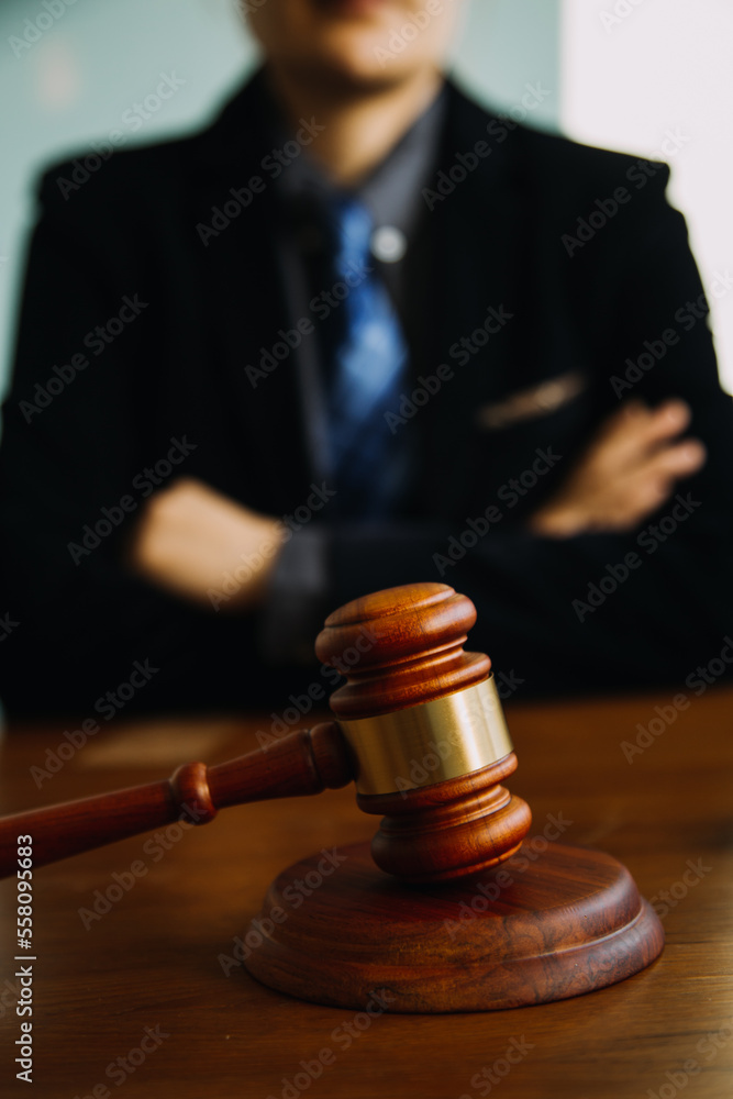 Business and lawyers discussing contract papers with brass scale on desk in office. Law, legal services, advice, justice and law concept picture with film grain effect Business and lawyers discussing contract papers with brass scale on desk in office. Law, legal services, advice, justice and law concept picture with film grain effect