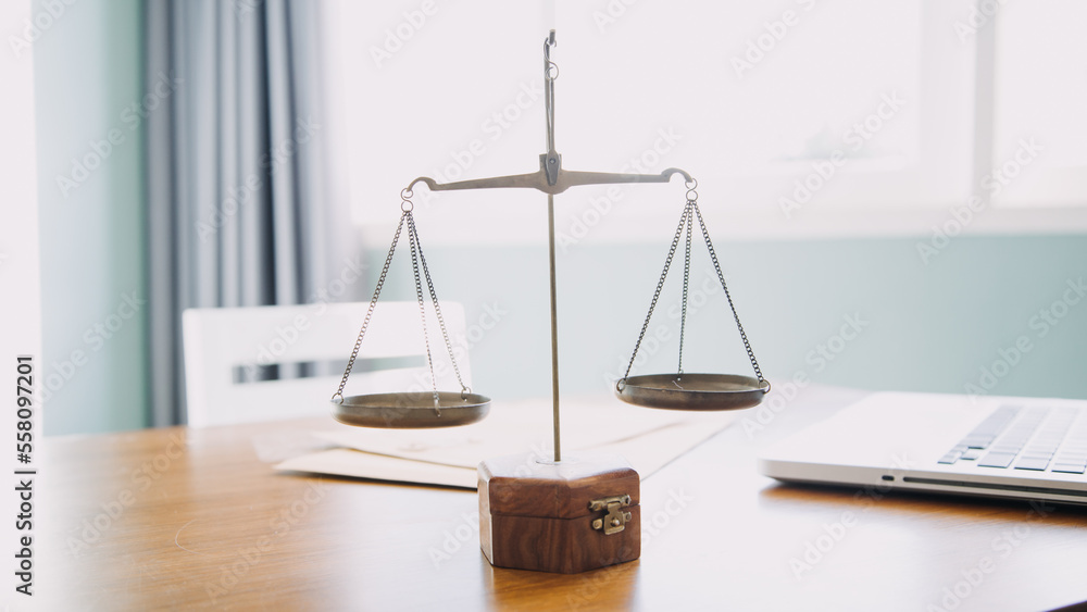 Business and lawyers discussing contract papers with brass scale on desk in office. Law, legal services, advice, justice and law concept picture with film grain effect Business and lawyers discussing contract papers with brass scale on desk in office. Law, legal services, advice, justice and law concept picture with film grain effect