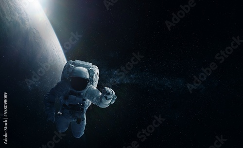 Astronaut and Earth. Elements of this image furnished by NASA. © wasan