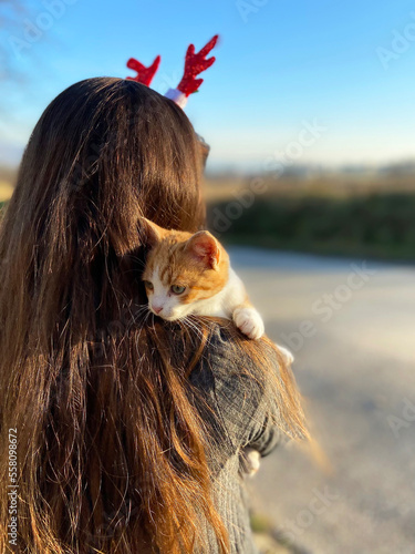 Kitten sitting on shoulder of girl