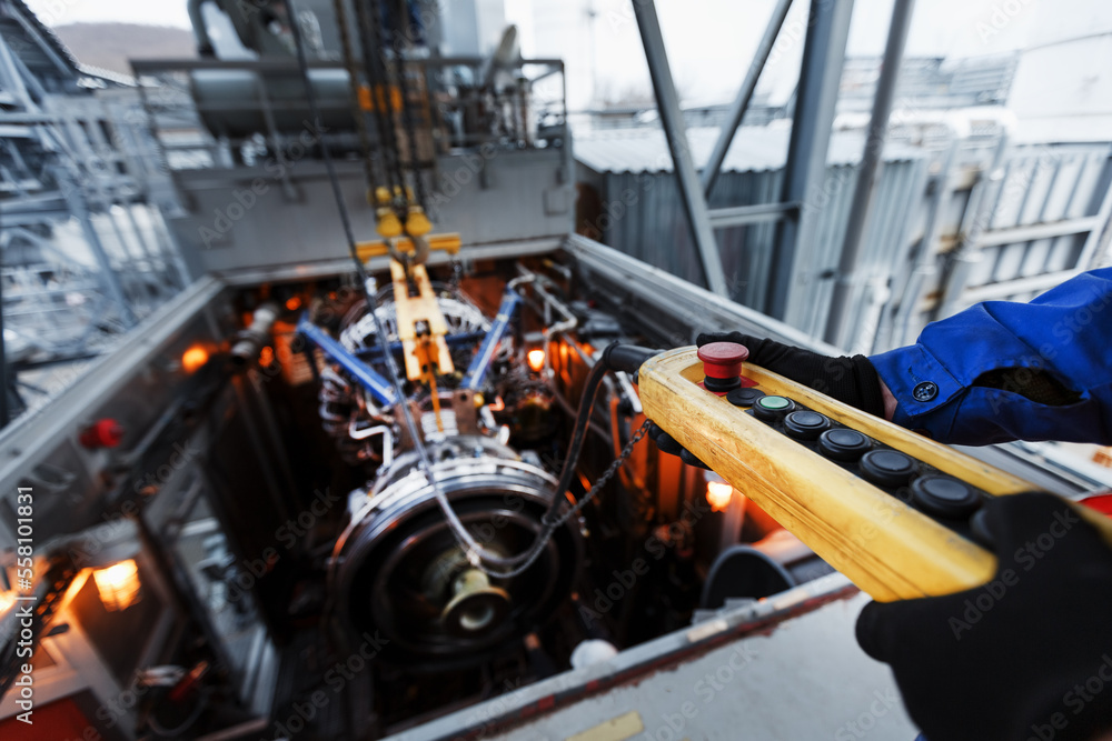 Fototapeta premium Yellow Remote control of a crane for installing a gas turbine plant for generating energy
