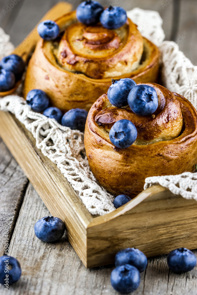 Handmade bakery in wooden tray with fresh blueberries Handmade bakery in wooden tray with fresh blueberries