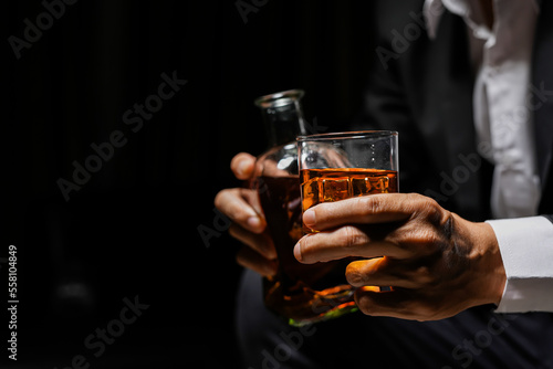 Closeup businessmen holding a glass of whiskey