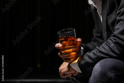 Closeup businessmen holding a glass of whiskey photo