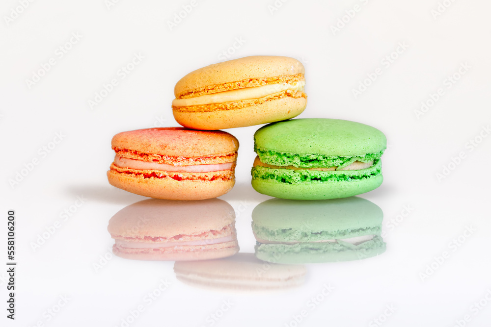 French macarons on a white plastic background with reflection .Macaron cookies French macarons on a white plastic background with reflection .Macaron cookies