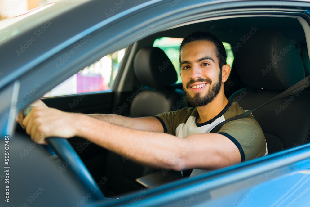 Attractive happy man enjoying driving the car Attractive happy man enjoying driving the car