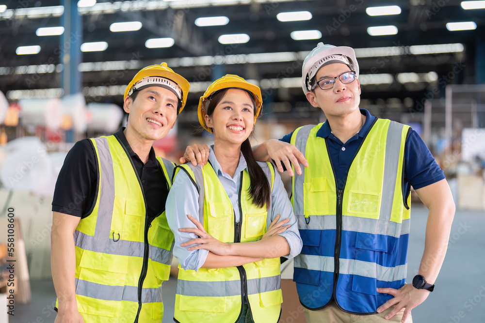Staff in large storage warehouse together portrait after work completed hand on shoulder smiling Staff in large storage warehouse together portrait after work completed hand on shoulder smiling
