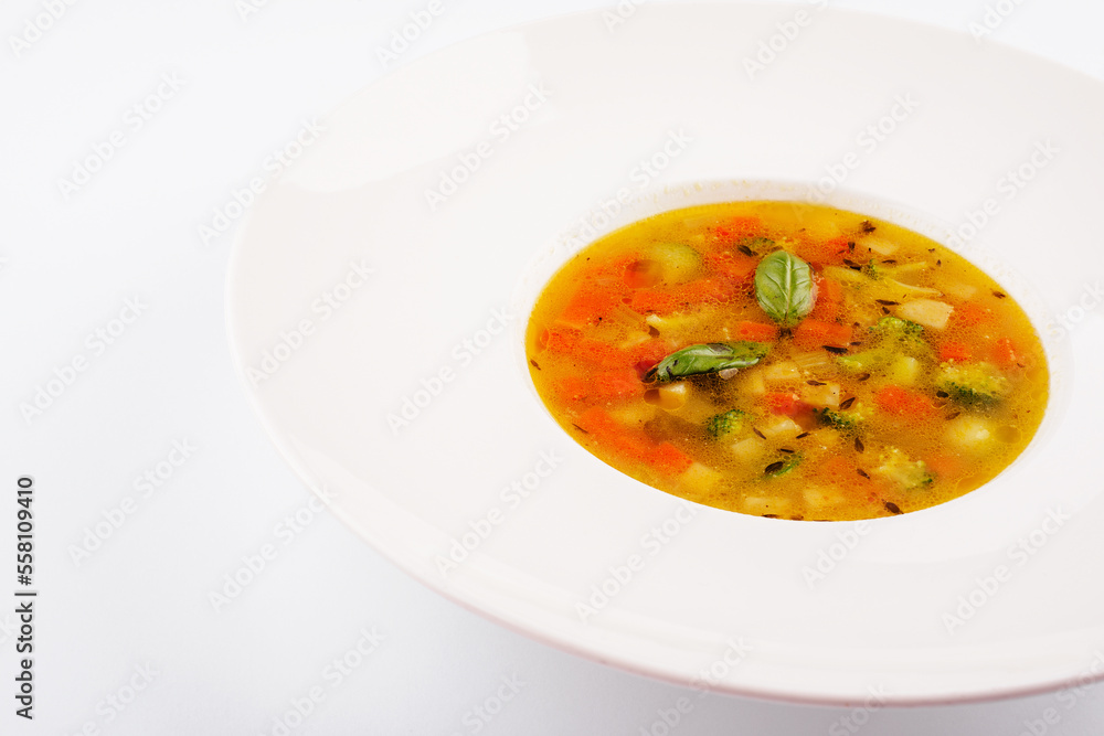 Plate of chicken soup isolated on white